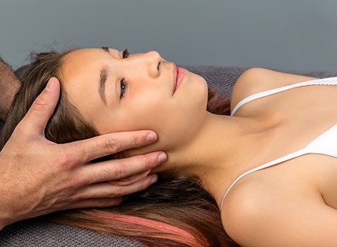 Young woman relaxing during cranial osteopathy treatment