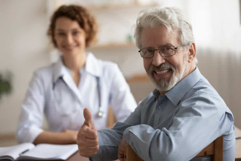 Portrait of smiling mature male patient show thumb up