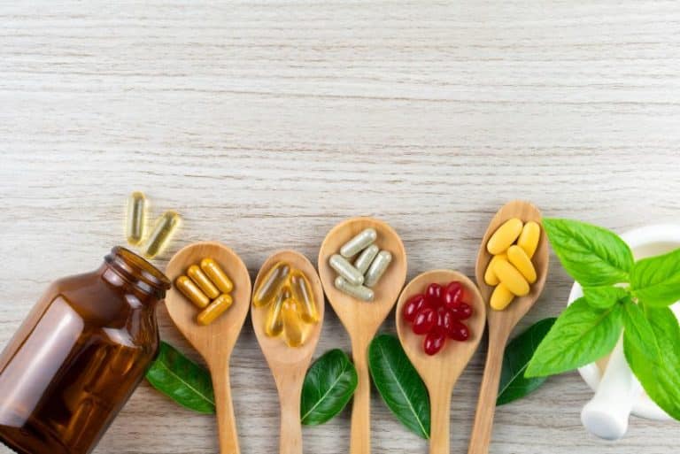 Variety of supplements arranged on wooden spoons 768x513